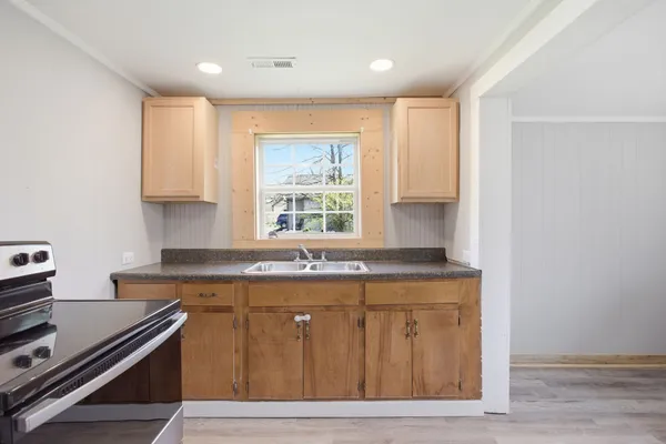 a kitchen with a stove and a window