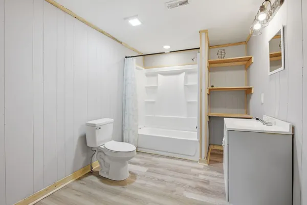 a bathroom with a toilet and a shower