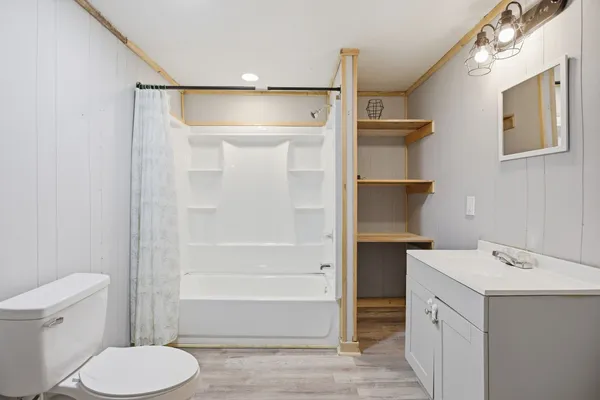 a bathroom with a toilet sink and shower