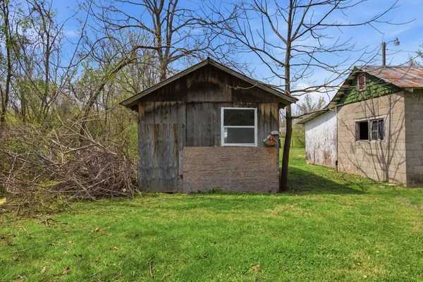 a front view of house with yard and garage