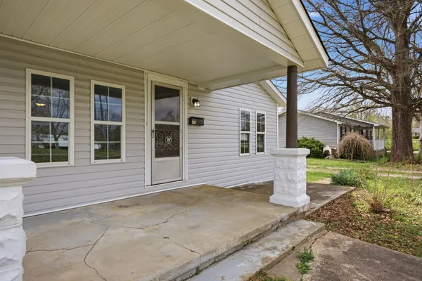 a house that has a big yard plants and large tree