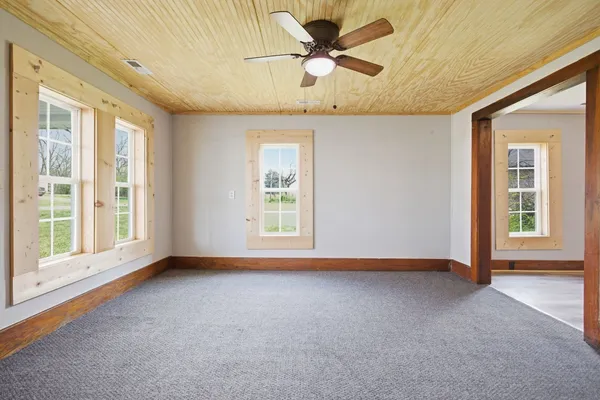 a view of room with a ceiling fan and window