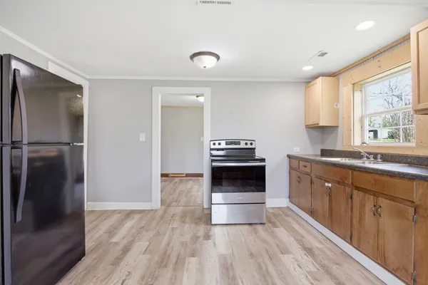 a kitchen with a refrigerator and a sink