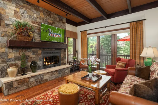 a living room with furniture a fireplace and a flat screen tv