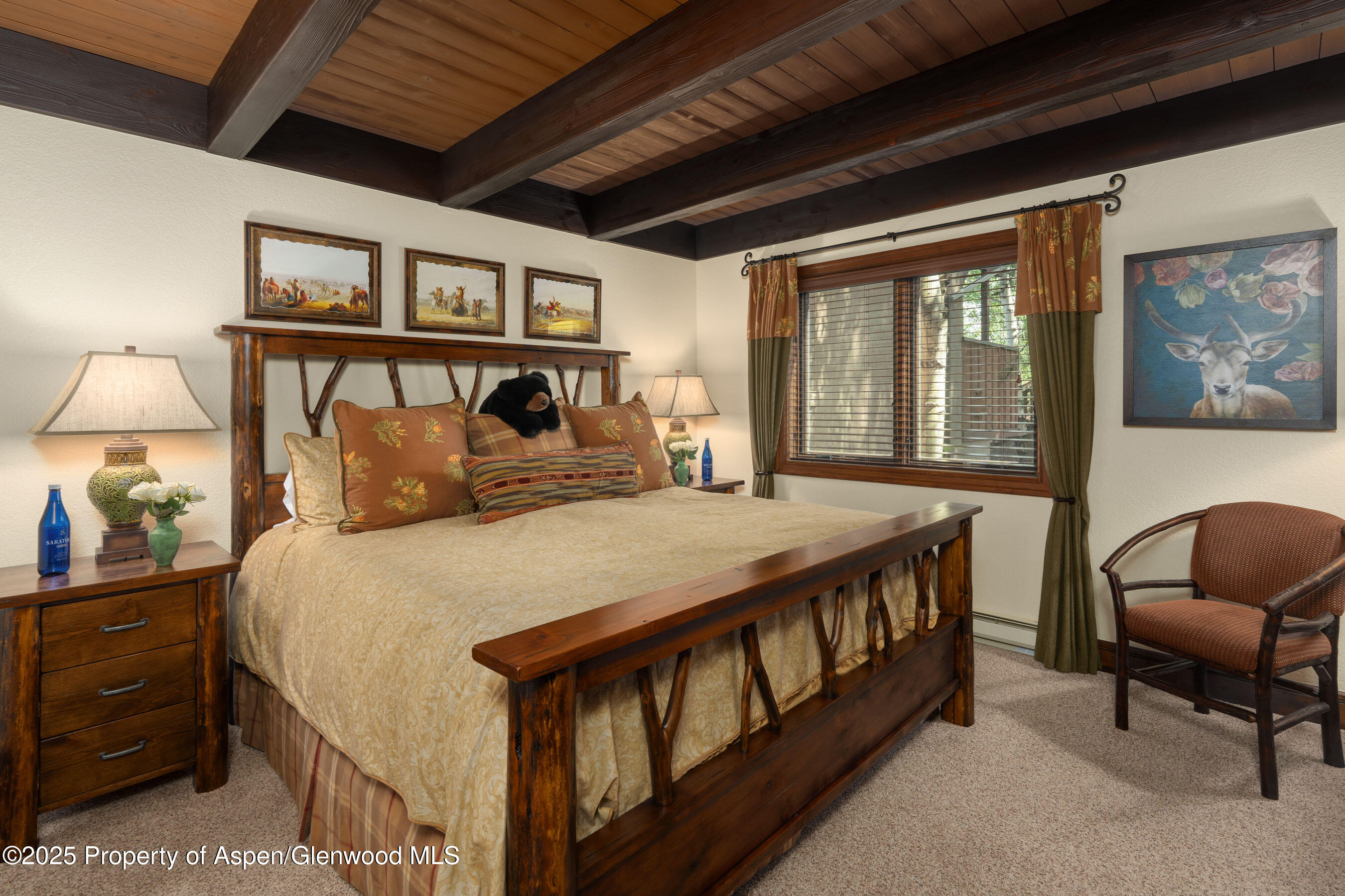 229 Faraway Road, Unit 28 Snowmass Village, CO 81615 - Photo 12 of 25 a bedroom with a bed a desk and chair with a large mirror next to a window