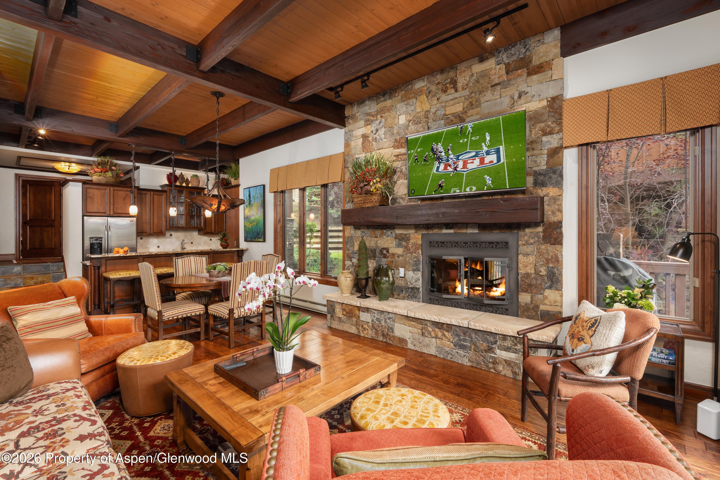 229 Faraway Road, Unit 28 Snowmass Village, CO 81615 - Photo 2 of 30 a living room with fireplace furniture and a flat screen tv