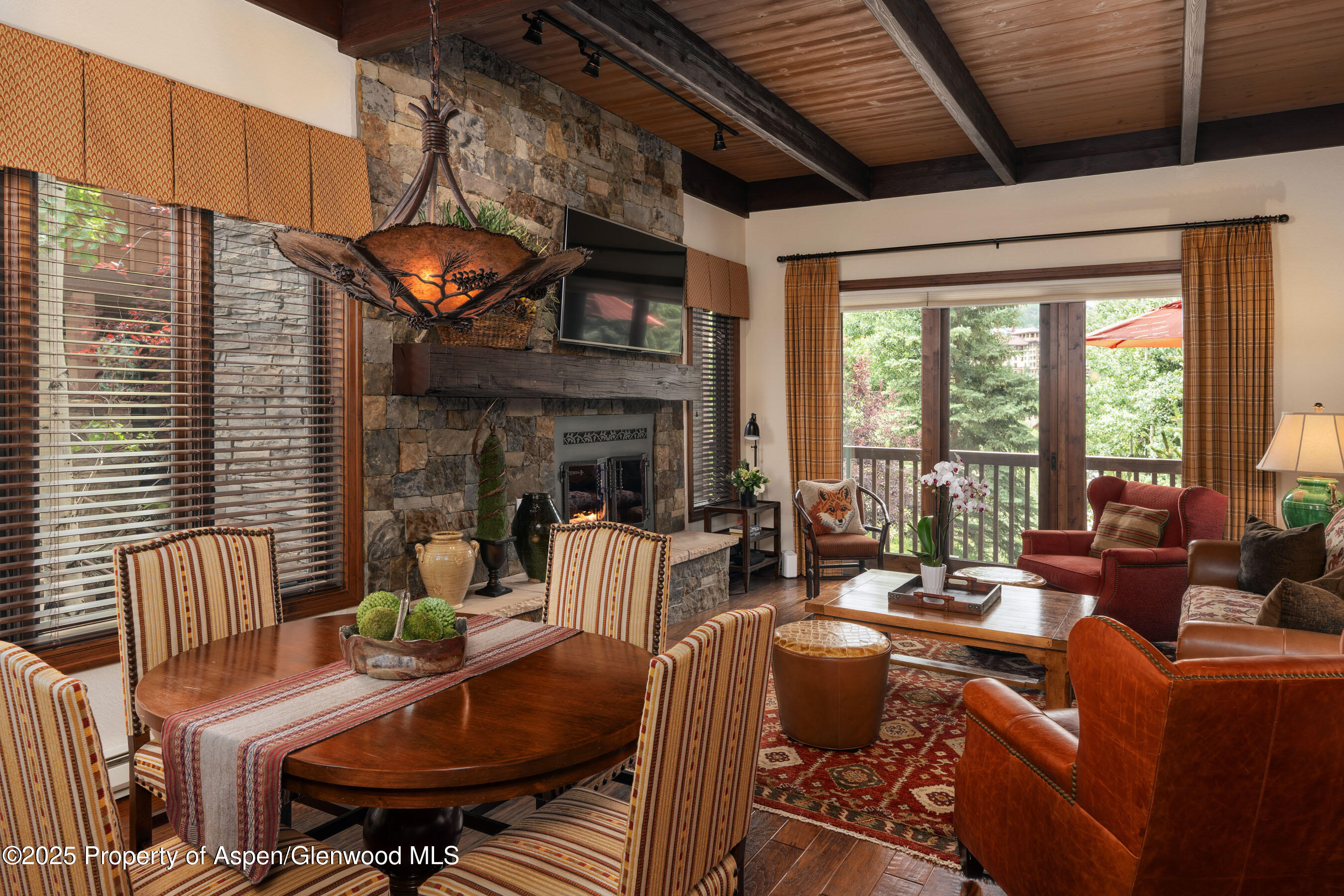 229 Faraway Road, Unit 28 Snowmass Village, CO 81615 - Photo 3 of 25 a living room with fireplace furniture and a large window