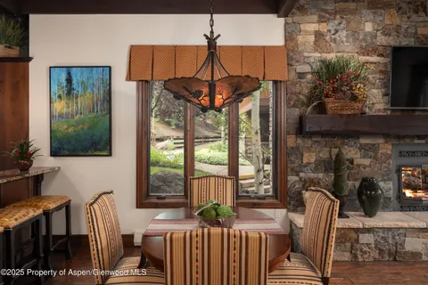 a living room with furniture a flat screen tv and a floor to ceiling window