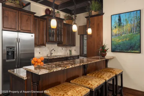 a kitchen with a stove and a refrigerator
