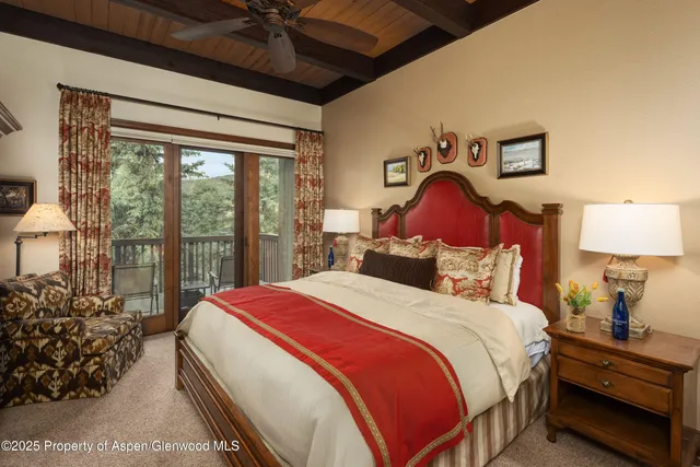 a bedroom with a bed a dresser next to a window