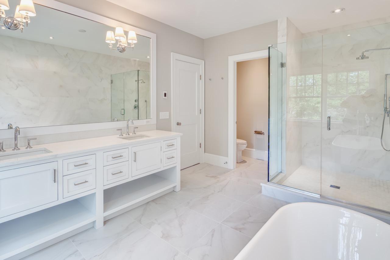 5 Top Sail Road Rowayton, CT 06853 - Photo 15 of 16 a spacious bathroom with double vanity a sink a mirror a shower and a bathtub