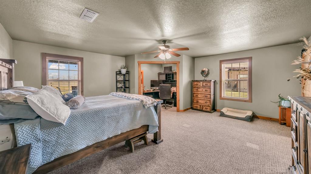 6500 Fm Road, Unit 1885 Weatherford, TX 76088 - Photo 12 of 40 a bed room with a bed and a chair