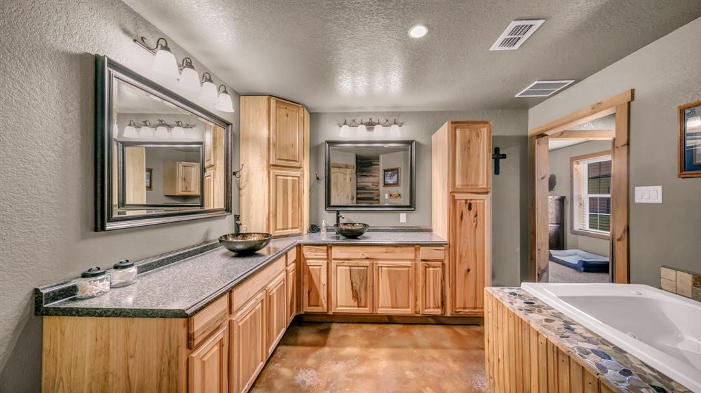 6500 Fm Road, Unit 1885 Weatherford, TX 76088 - Photo 16 of 40 a spacious bathroom with a granite countertop double vanity sink a mirror and a bathtub