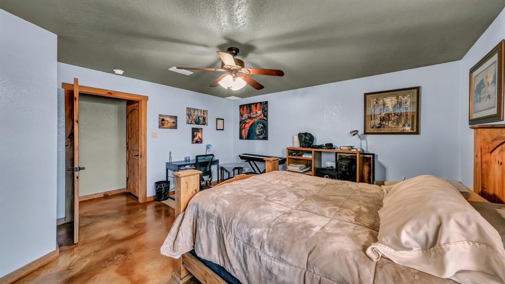 6500 Fm Road, Unit 1885 Weatherford, TX 76088 - Photo 19 of 40 a bed room with a bed and a ceiling fan