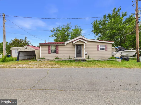 a view of a house with a backyard and a garage