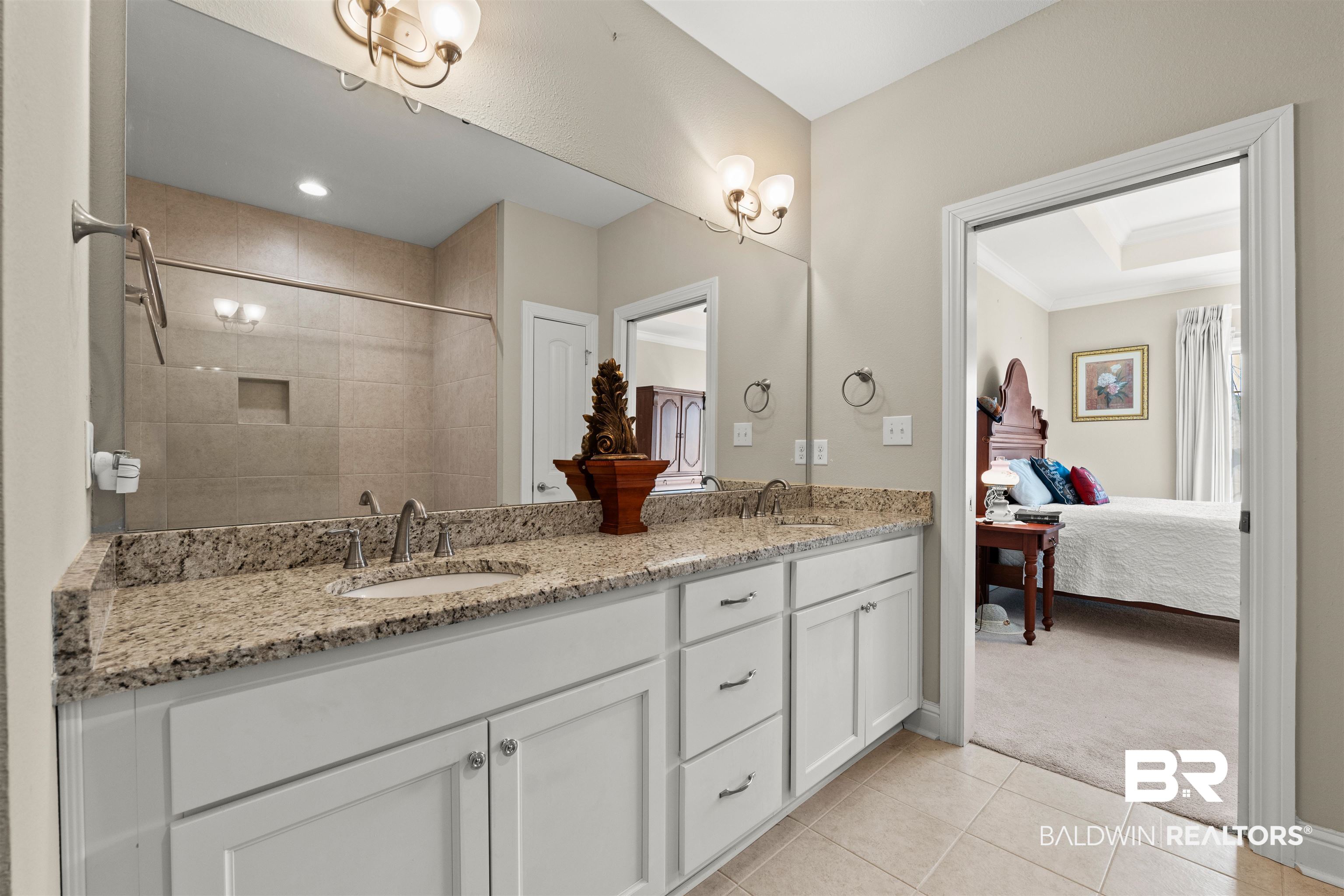 301 Holmes Avenue, Unit 301 Foley, AL 36535 - Photo 23 of 54 Full bath with tile patterned flooring, double vanity, a tile shower, and a sink