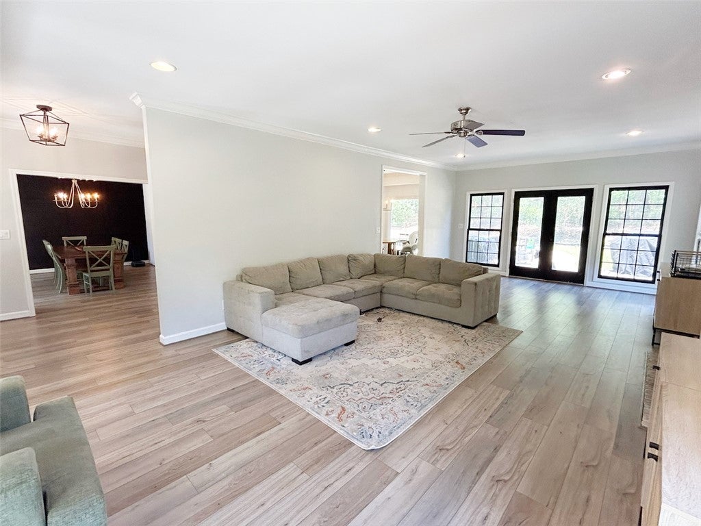 2004 Moores Mill Road Lanett, AL 36863 - Photo 16 of 50 Bright and airy open-concept living area with gleaming wood flooring throughout.