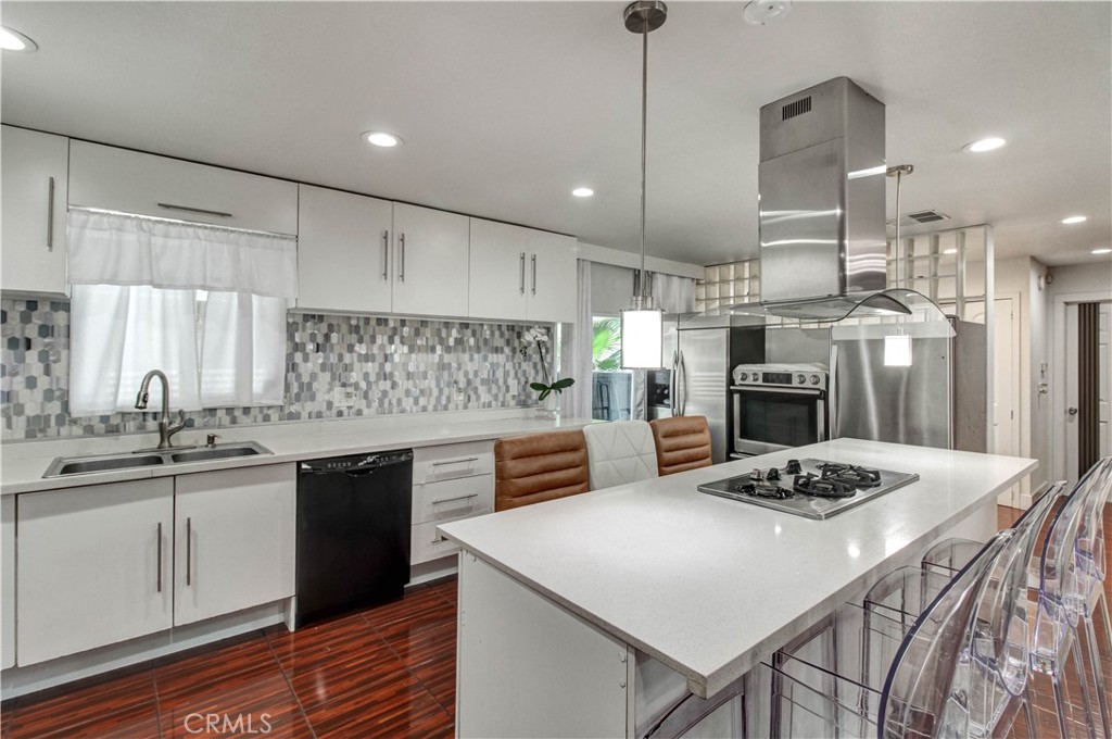 1025 South Riverside Avenue, Unit 26 Rialto, CA 92376 - Photo 13 of 27 a kitchen with kitchen island a sink table and chairs