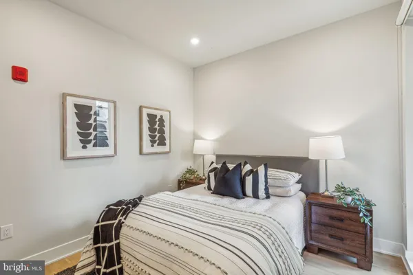 a bedroom with a bed and a lamp