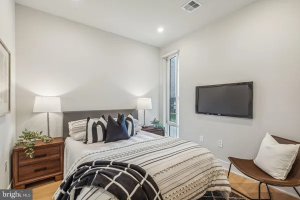 a bedroom with a bed and a television