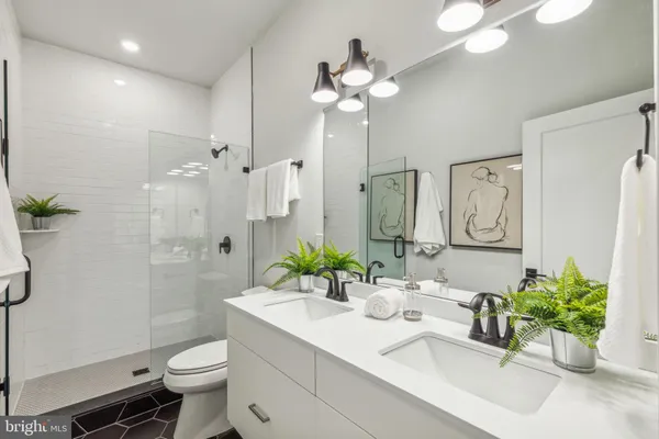 a bathroom with a sink a toilet and a shower