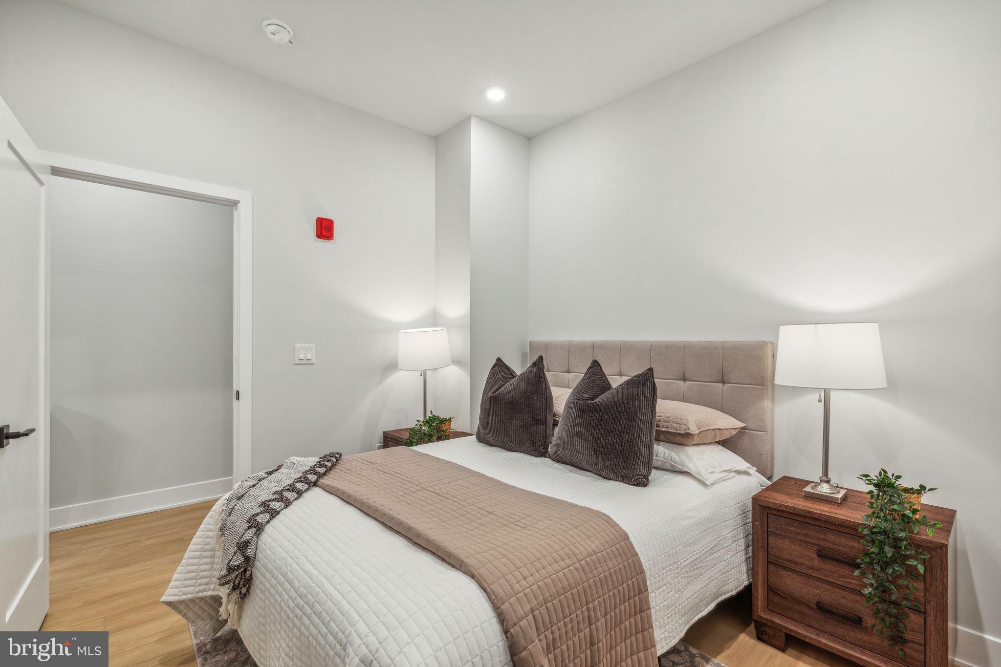 6910 Ridge Avenue, Unit 114 Philadelphia, PA 19128 - Photo 9 of 20 a bedroom with a bed and a night stand