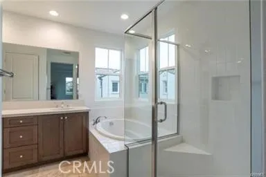 a bathroom with a granite countertop sink a mirror and shower