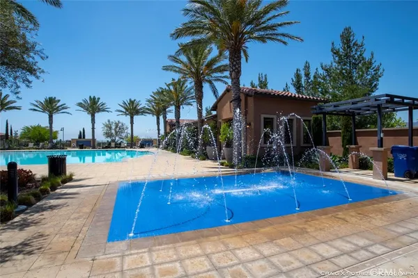 a view of a backyard patio and swimming pool