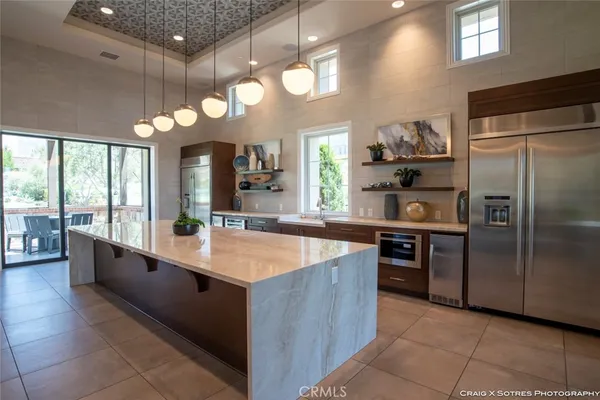 a large kitchen with kitchen island granite countertop a large counter top and stainless steel appliances