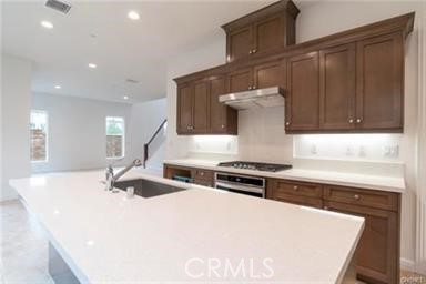 20801 Bur Oak Circle Porter Ranch, CA 91326 - Photo 3 of 35 a kitchen with a stove and a sink