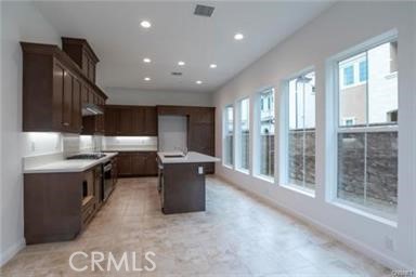 20801 Bur Oak Circle Porter Ranch, CA 91326 - Photo 4 of 35 a kitchen with stainless steel appliances granite countertop a stove top oven a sink and a refrigerator