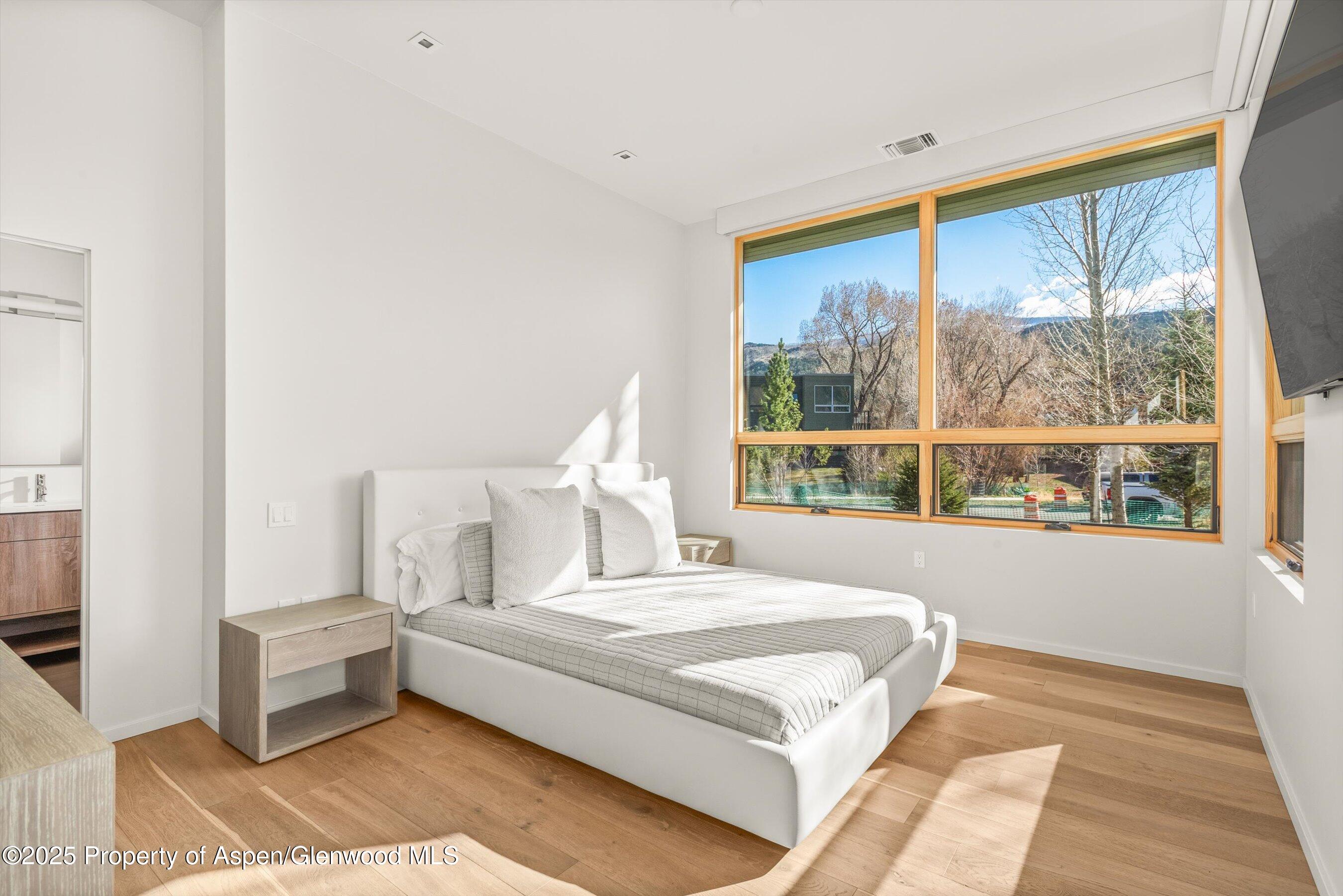 104 Evans Road, Unit 105 Basalt, CO 81621 - Photo 12 of 23 a bedroom with a large bed and a large window