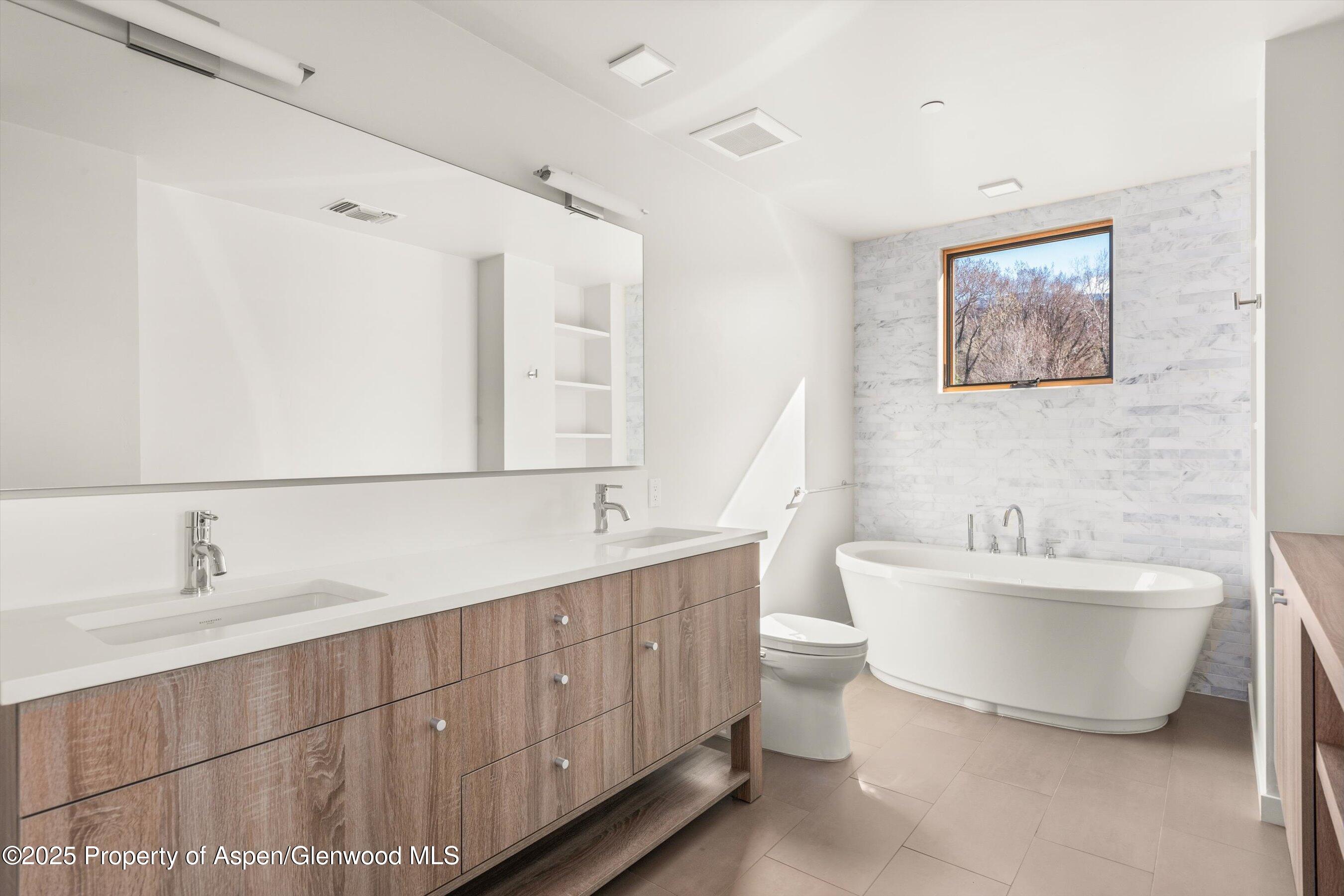 104 Evans Road, Unit 105 Basalt, CO 81621 - Photo 15 of 23 a bathroom with a double vanity sink mirror and toilet
