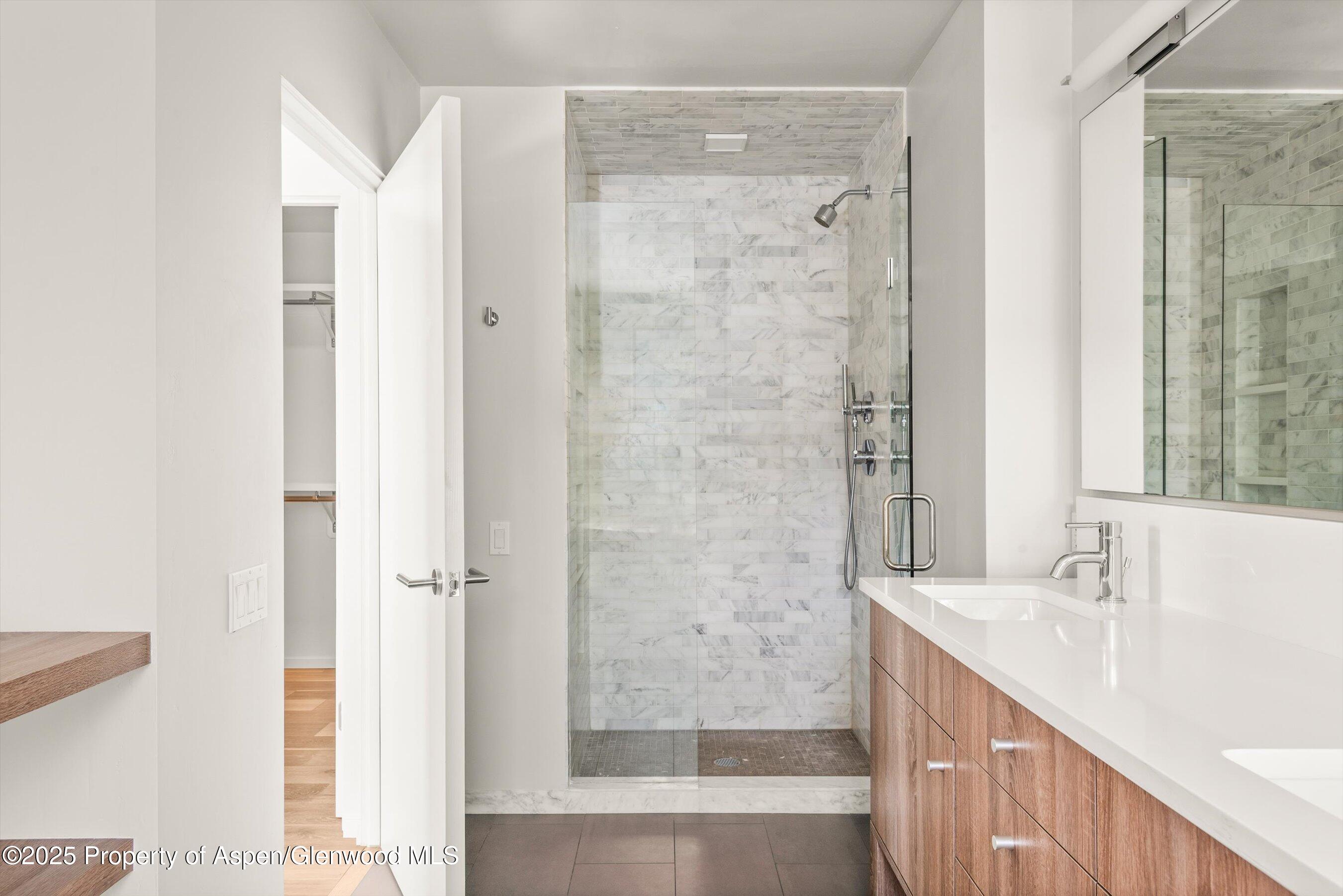 104 Evans Road, Unit 105 Basalt, CO 81621 - Photo 16 of 23 a bathroom with a shower sink and mirror