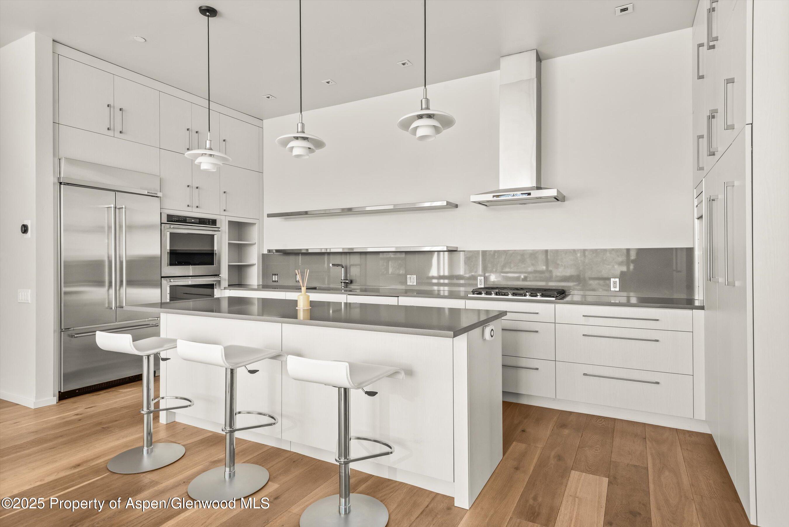 104 Evans Road, Unit 105 Basalt, CO 81621 - Photo 9 of 23 a kitchen with stainless steel appliances granite countertop a sink a stove and a refrigerator