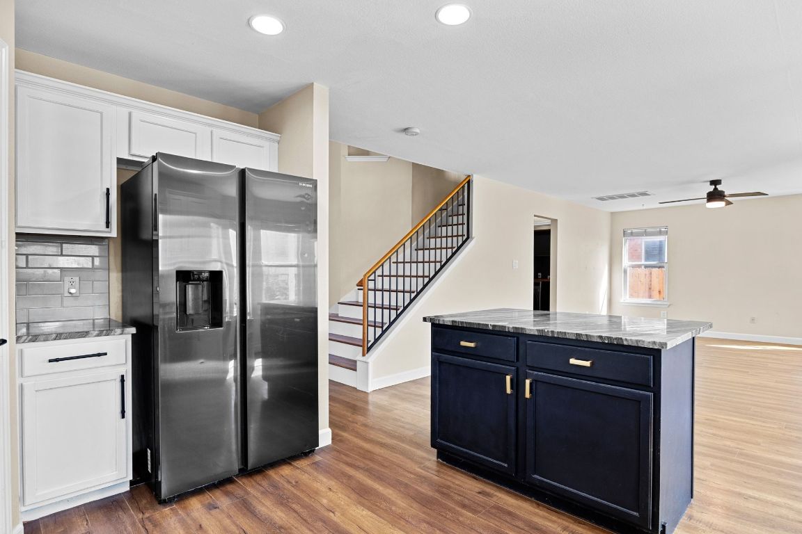 1405 Ty Cobb Place Round Rock, TX 78665 - Photo 15 of 33 a kitchen with stainless steel appliances granite countertop a refrigerator and a sink