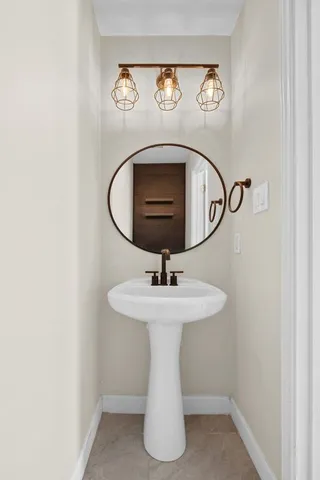 a bathroom with a sink and mirror