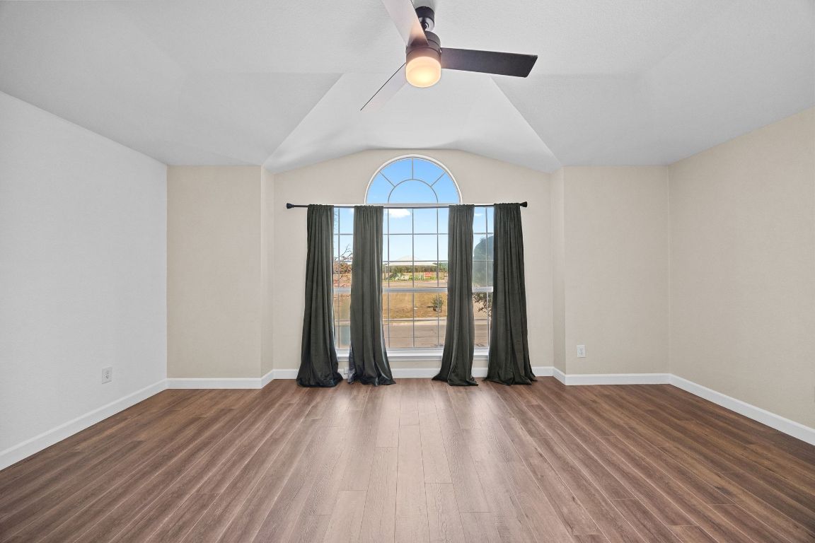 1405 Ty Cobb Place Round Rock, TX 78665 - Photo 22 of 33 an empty room with wooden floor and windows