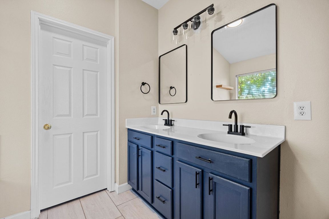 1405 Ty Cobb Place Round Rock, TX 78665 - Photo 24 of 33 a bathroom with a double vanity sink and mirror