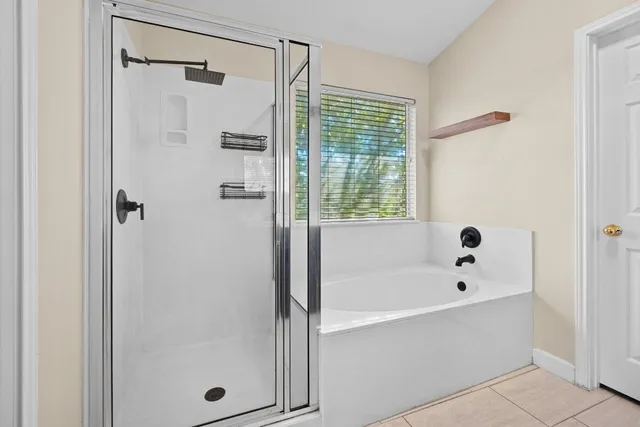 a bathroom with a bathtub and shower