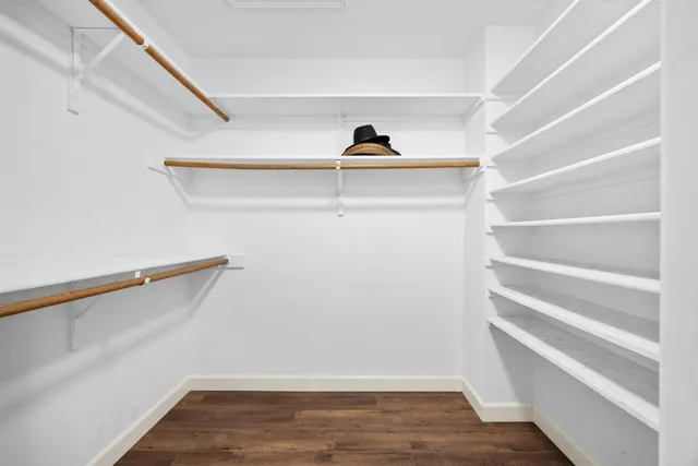 a view of walk in closet with empty racks