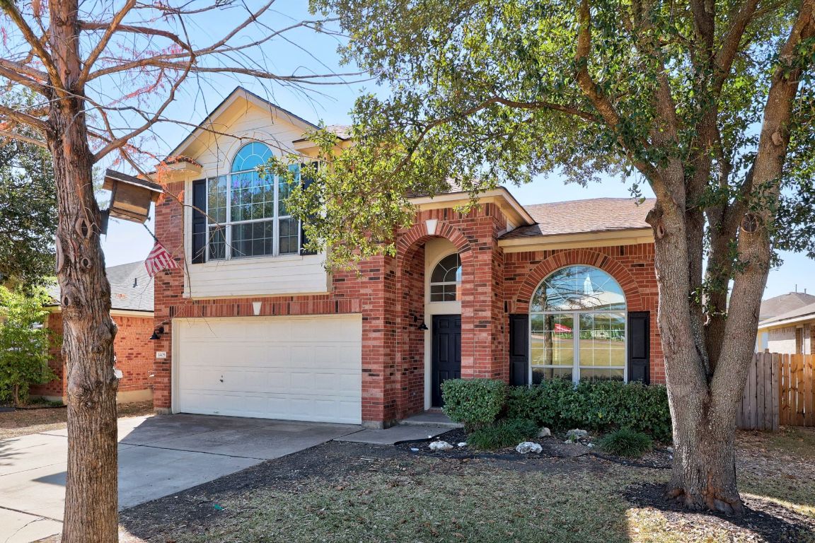 1405 Ty Cobb Place Round Rock, TX 78665 - Photo 3 of 33 a front view of a house with a yard