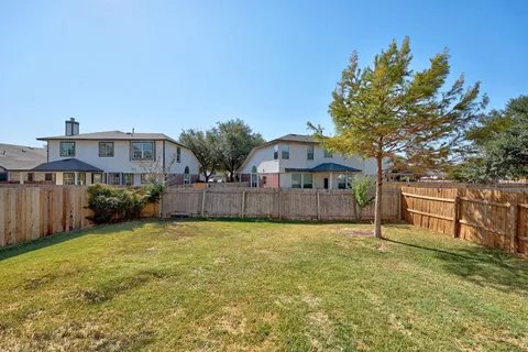 a view of a house with a yard and deck