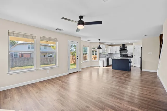 a view of kitchen with cabinets and wooden floor