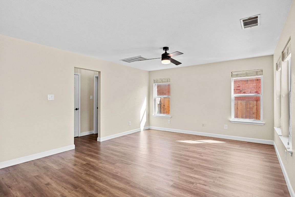 1405 Ty Cobb Place Round Rock, TX 78665 - Photo 10 of 33 a view of an empty room with wooden floor and a window