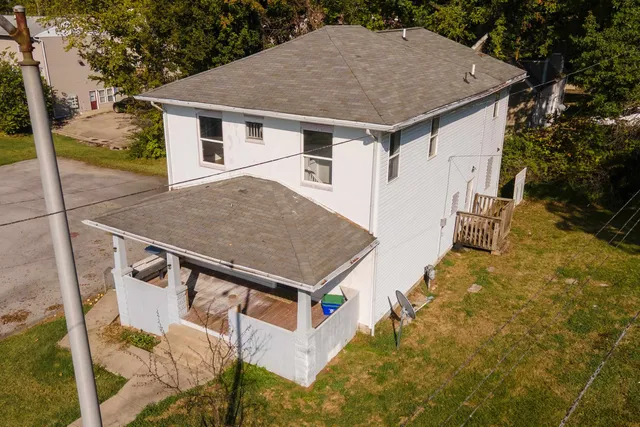 a aerial view of a house with a yard