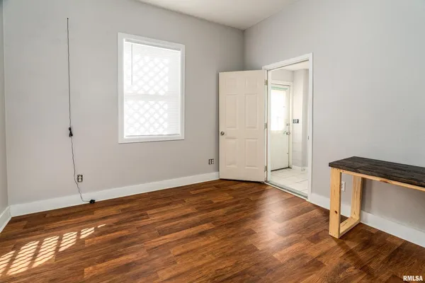 a bathroom with a toilet sink vanity and mirror