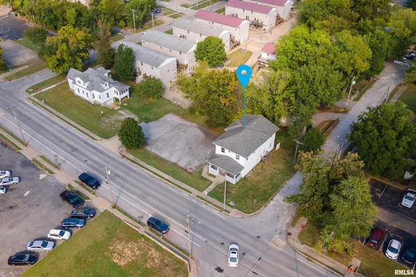 an aerial view of residential houses with outdoor space