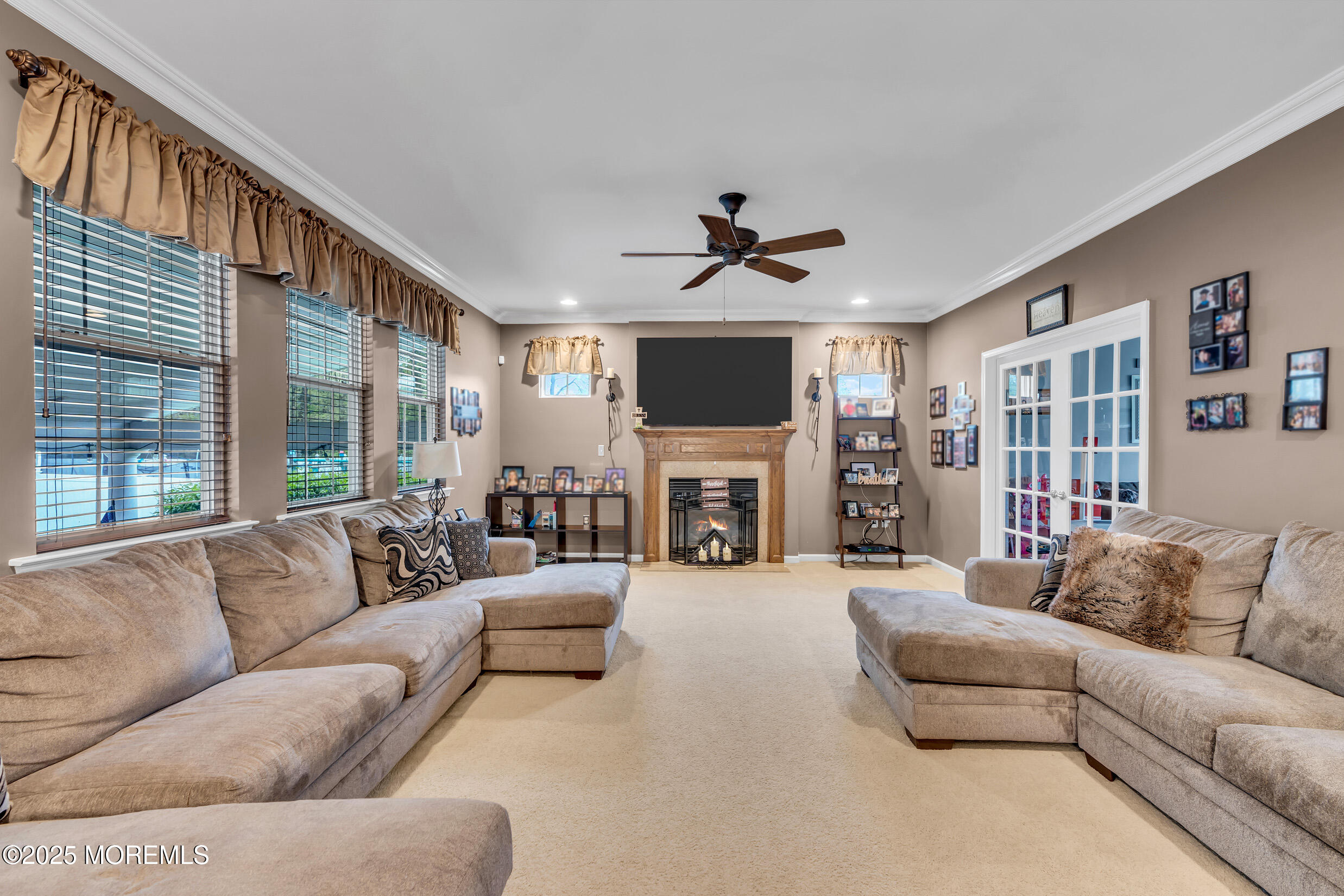6 Firenze Road Jackson, NJ 08527 - Photo 14 of 57 a living room with furniture a fireplace and a flat screen tv