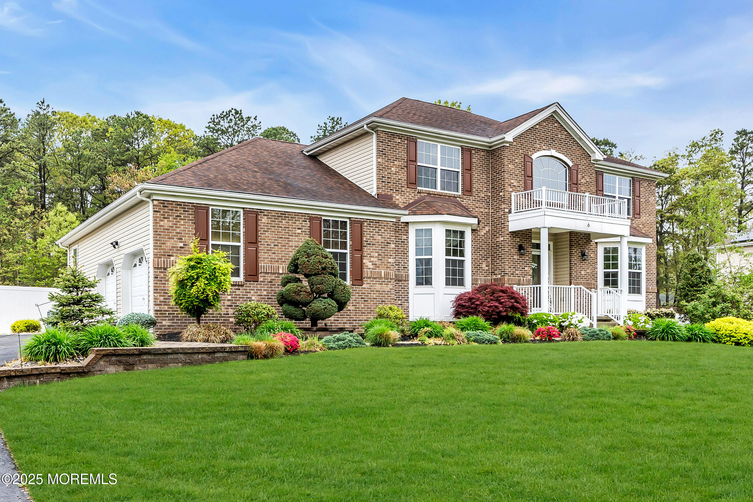 6 Firenze Road Jackson, NJ 08527 - Photo 4 of 57 a front view of a house with a garden and plants